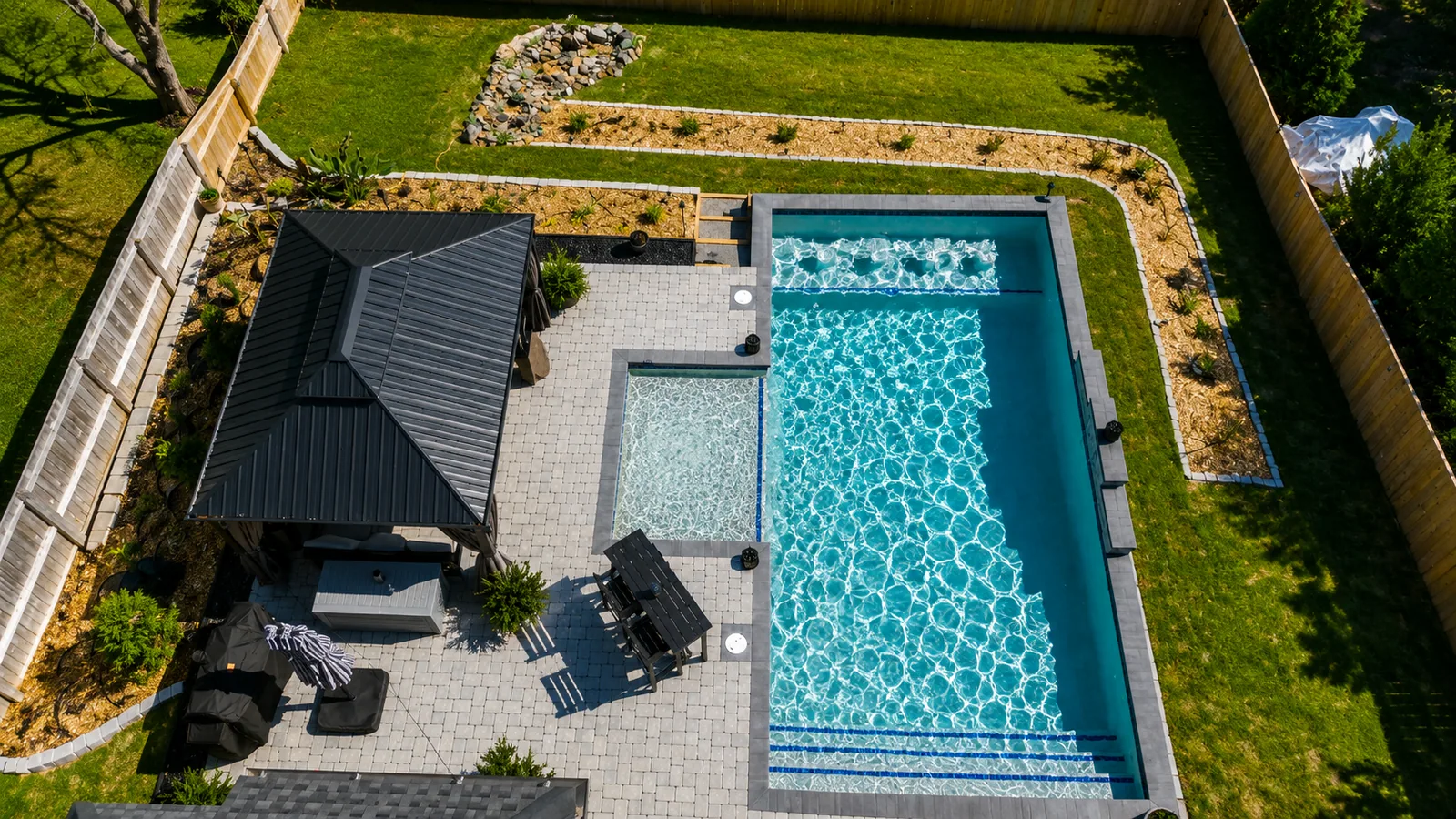 Aerial view of a custom backyard pool built by Neway Pools Aerial view of a custom backyard pool built by Neway Pools