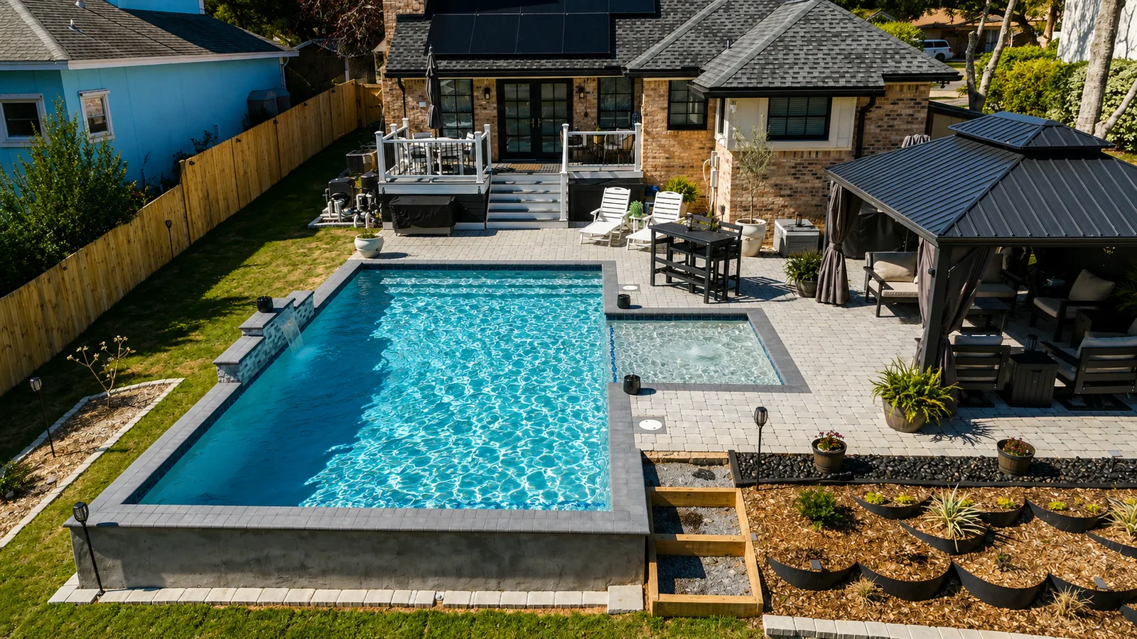 Aerial view of a custom backyard pool built by Neway Pools Aerial view of a custom backyard pool built by Neway Pools