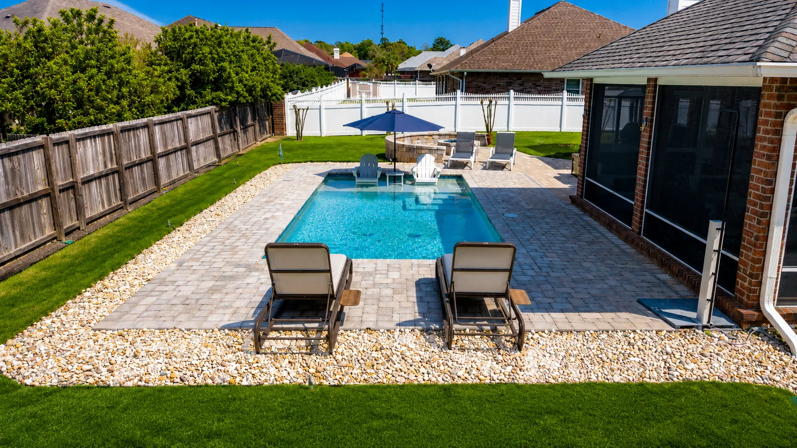 Custom rectangular swimming pool with paver decking