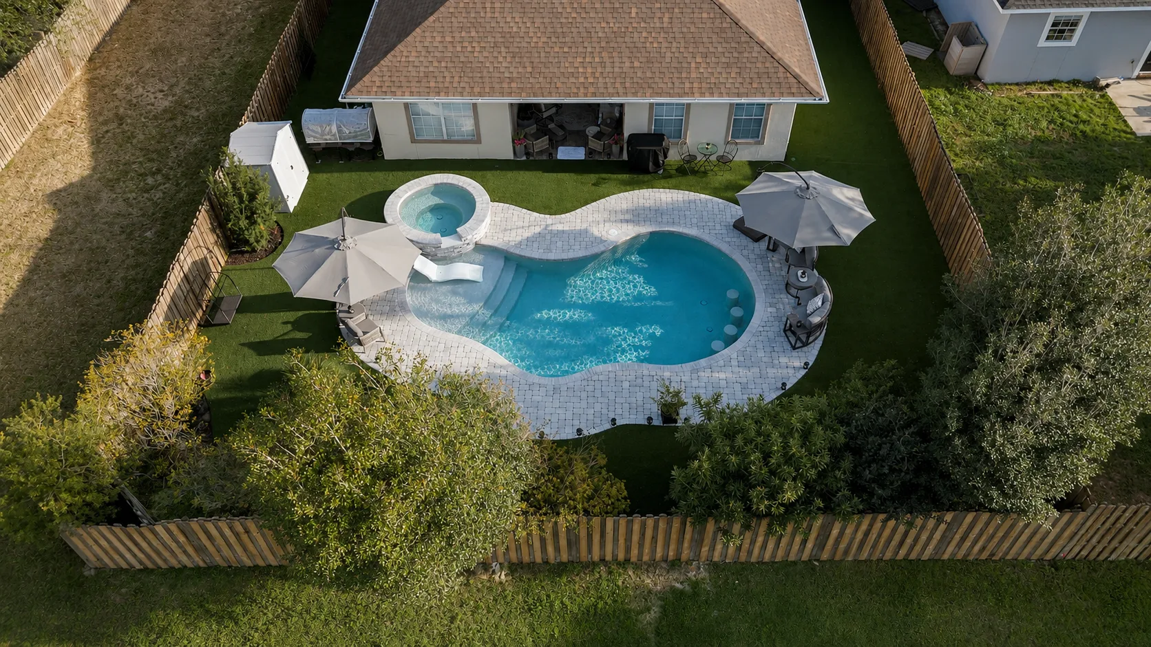 Aerial view of a custom backyard pool built by Neway Pools