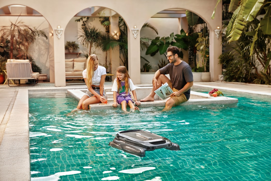 family enjoying a custom pool and spa combo in their backyard family enjoying a custom pool and spa combo in their backyard
