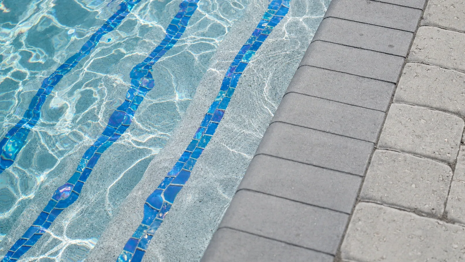 Waterline tile and coping detail on a custom Neway pool