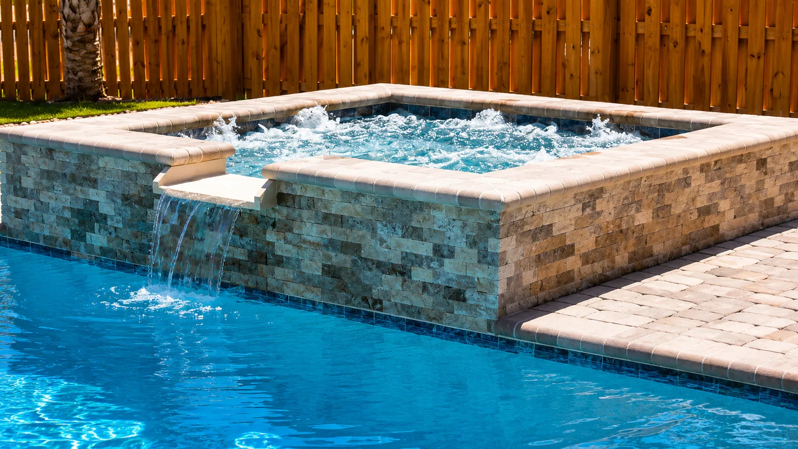 Raised spa with a spillway into a custom Neway pool Raised spa with a spillway into a custom Neway pool
