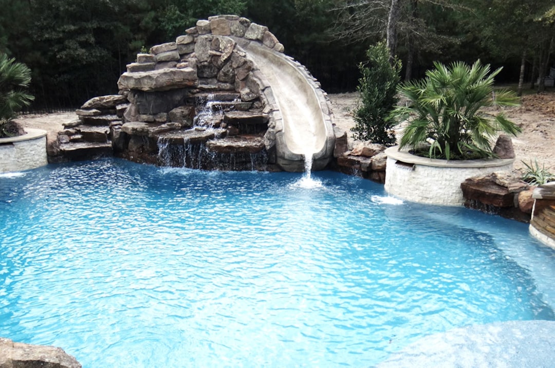 custom gunite pool with a unique water feature like a waterfall or grotto - custom swimming pool builders custom gunite pool with a unique water feature like a waterfall or grotto - custom swimming pool builders